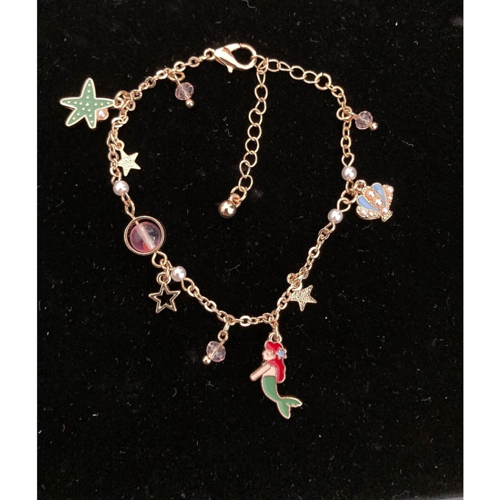 Ariel Gold tone Charms bracelet